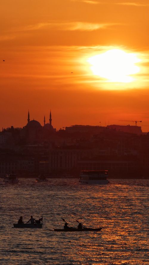 Free Silhouette of kayakers on the Bosphorus with a stunning sunset in the background, Istanbul. Stock Photo