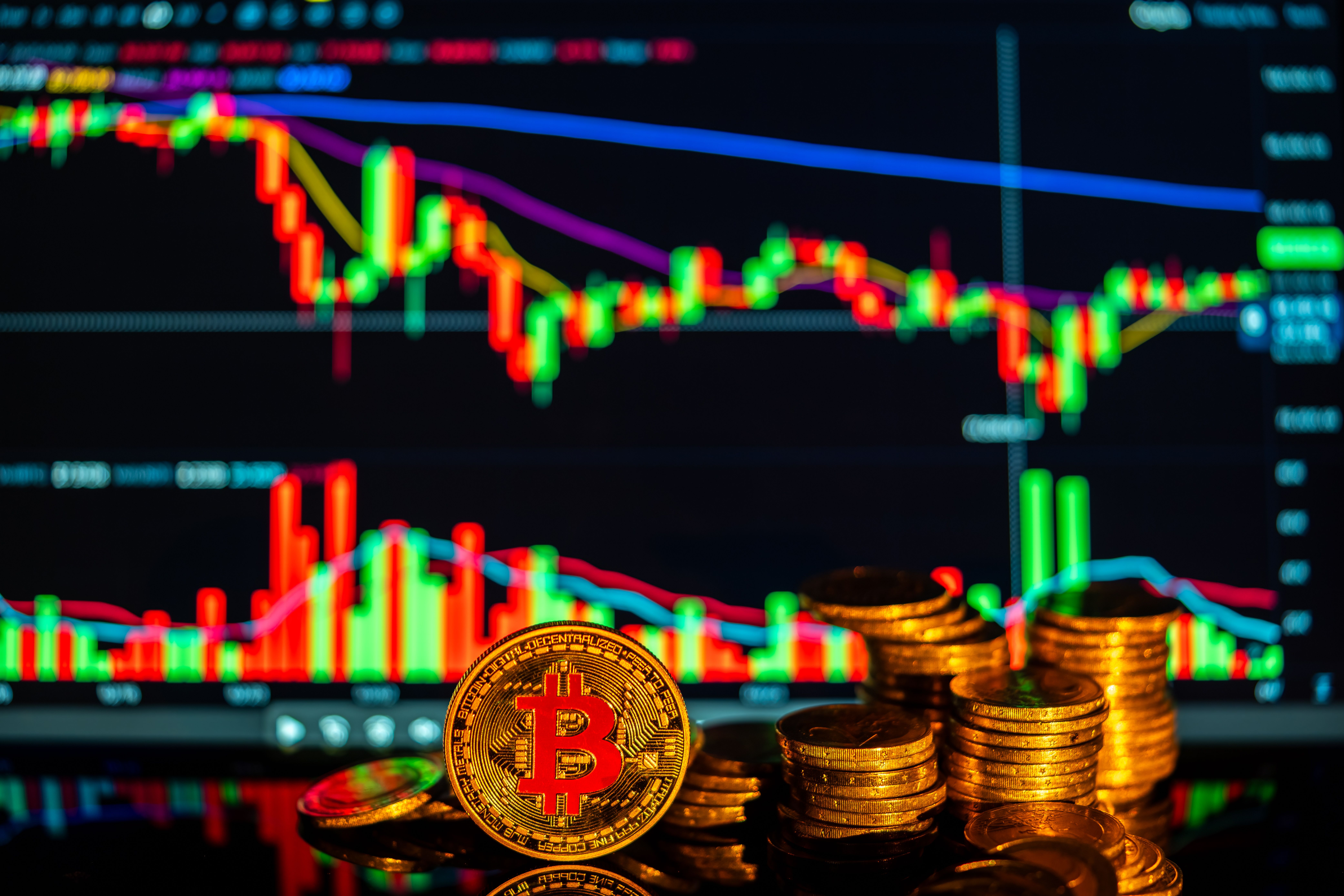 Golden bitcoins with financial growth charts illustrating investment opportunities in cryptocurrency.