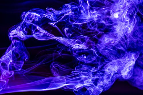 Free A mesmerizing display of blue smoke swirling ethereally against a dark background, creating an abstract visual effect. Stock Photo