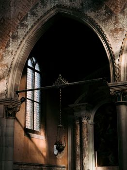 Gothic arch inside a Venetian church with dramatic lighting and intricate details.