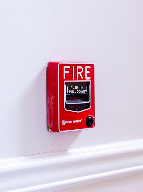 Free Close-up view of a red fire alarm switch with clear text instructions on a white wall. Stock Photo
