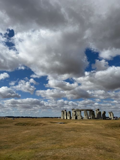 Free Capture of Stonehenge against a backdrop of dramatic clouds, showcasing the iconic prehistoric monument. Stock Photo