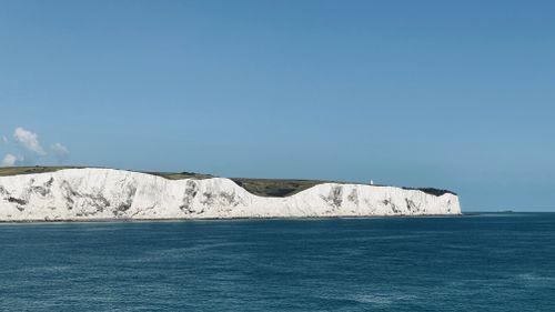 Free A stunning view of the White Cliffs of Dover from the sea on a clear summer day. Stock Photo