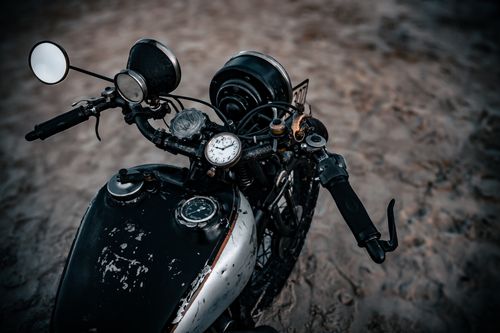 Free Close-up of a classic motorcycle handlebar shot on a sandy beach in Denmark. Stock Photo