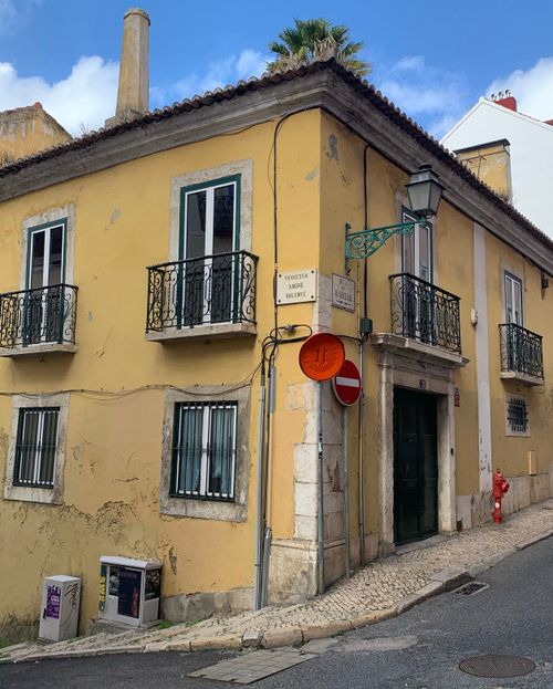 Free A picturesque yellow building with traditional balconies in Lisbon, Portugal. Stock Photo
