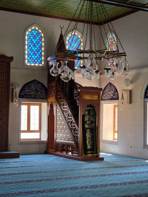 Free Vibrant stained glass and intricate woodwork in an Istanbul mosque provide a serene atmosphere. Stock Photo