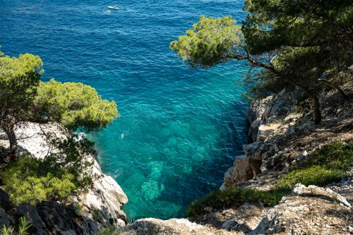 Free A breathtaking view of rocky cliffs and the turquoise Mediterranean Sea in Marseille, France. Stock Photo