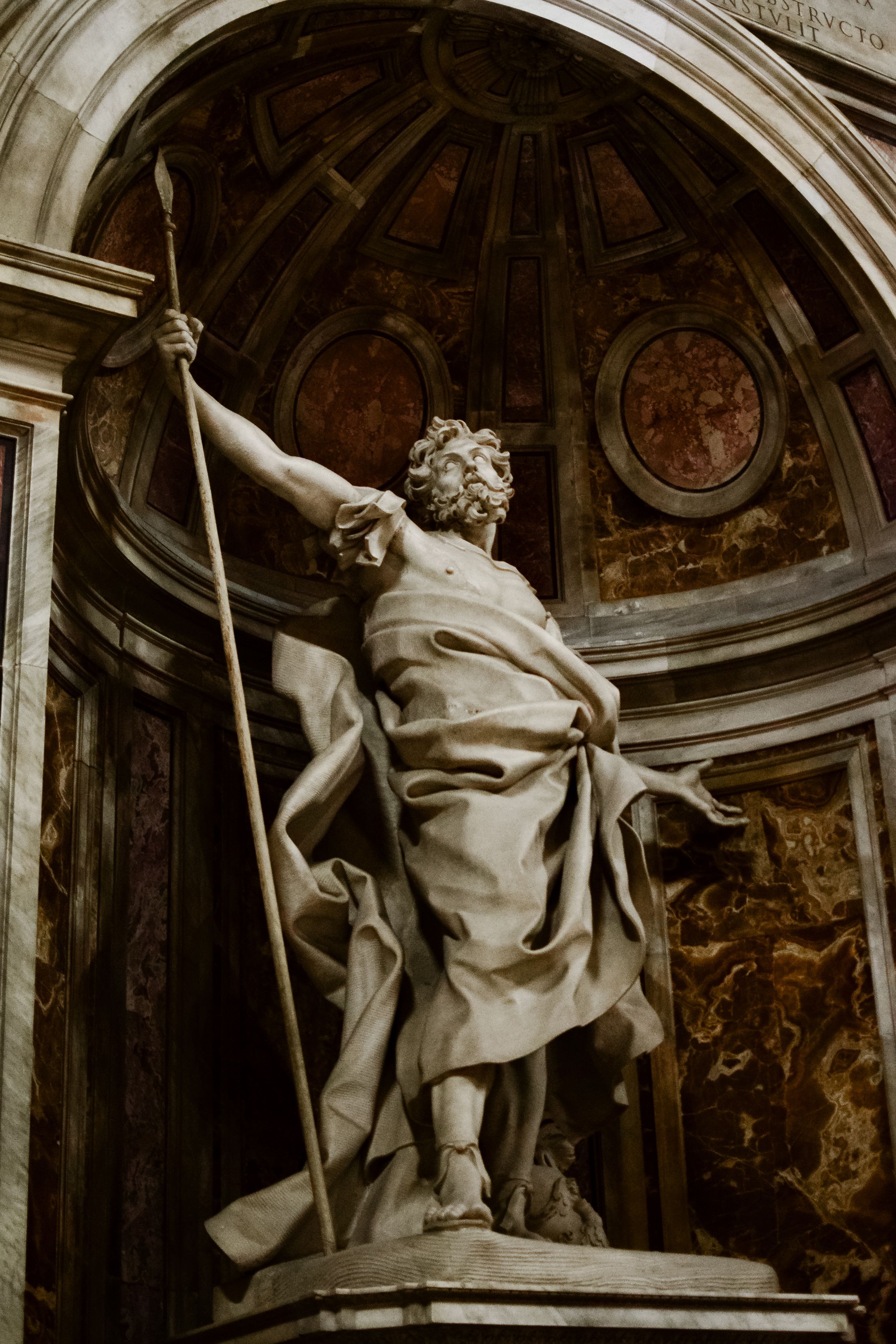Marble statue of a majestic figure inside a historic Italian cathedral, showcasing intricate artistry.