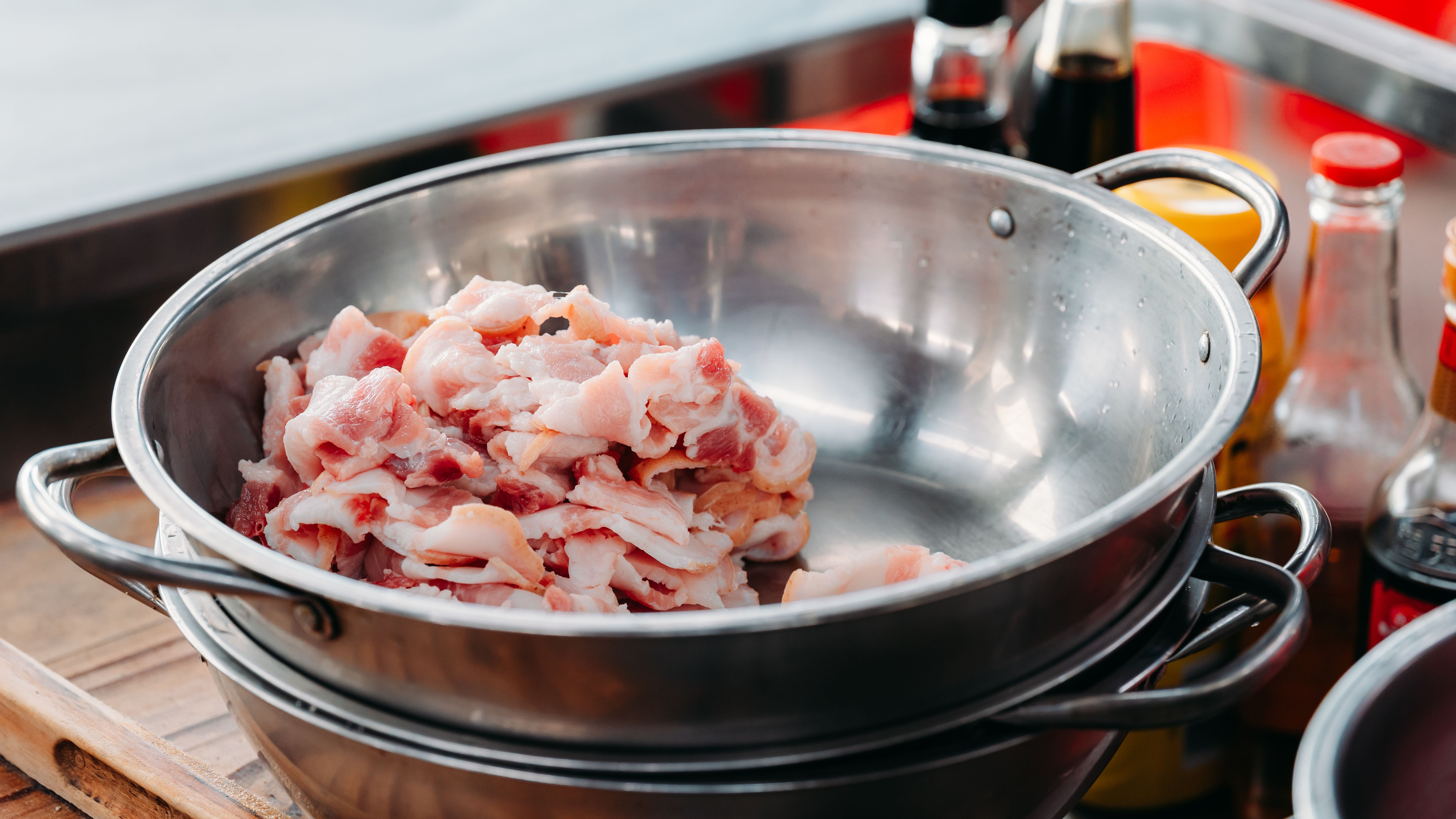 Raw meat in a stainless steel bowl