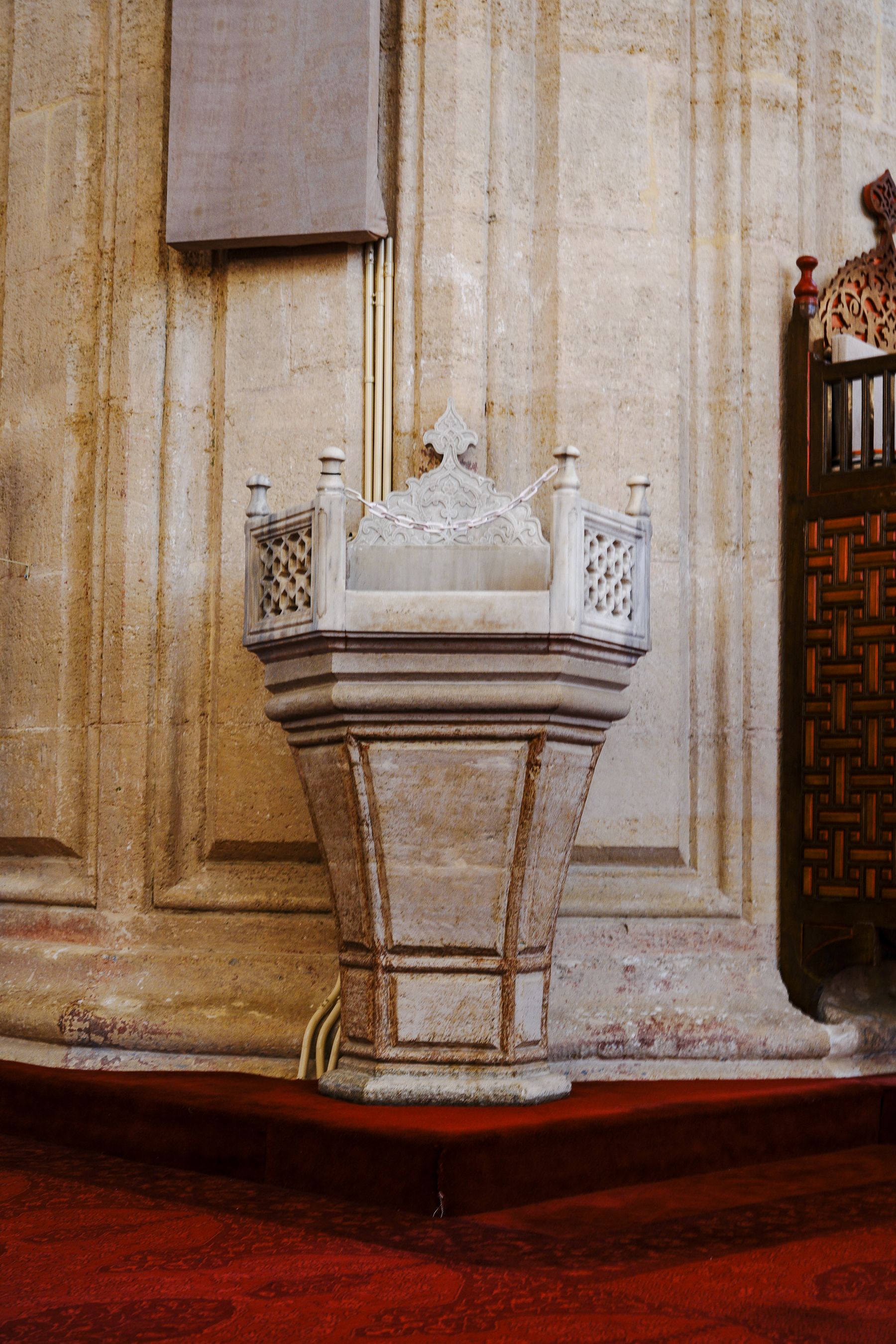 Intricately designed marble pulpit inside a mosque in Edirne, showcasing Ottoman architecture.