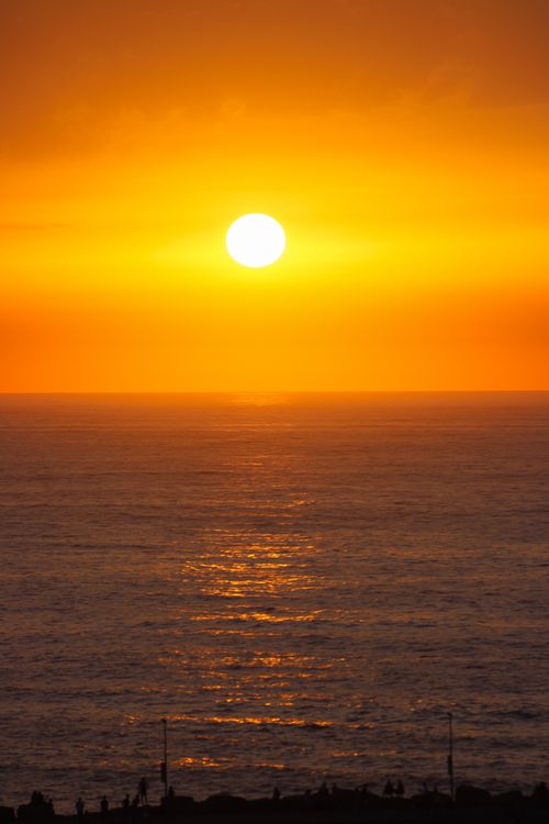 Free Breathtaking sunset over the Atlantic Ocean in Rabat, Morocco with vibrant orange hues. Stock Photo