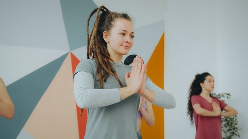 Free A diverse group of people practicing yoga indoors, focusing on mindfulness and relaxation. Stock Photo