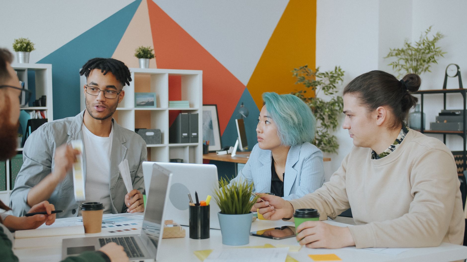 Diverse team engaging in a collaborative meeting in a vibrant, modern office space.