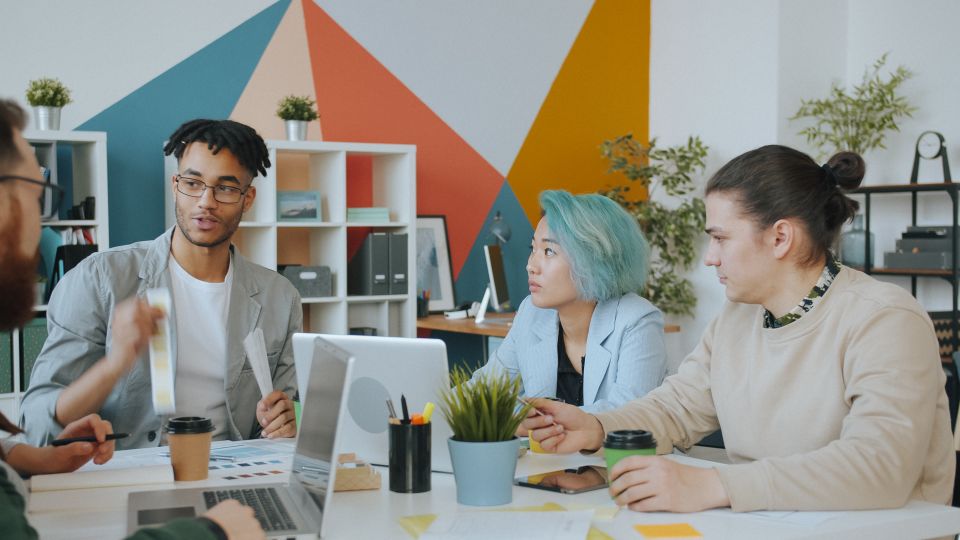Marketing agency team discussing ideas in a colourful office