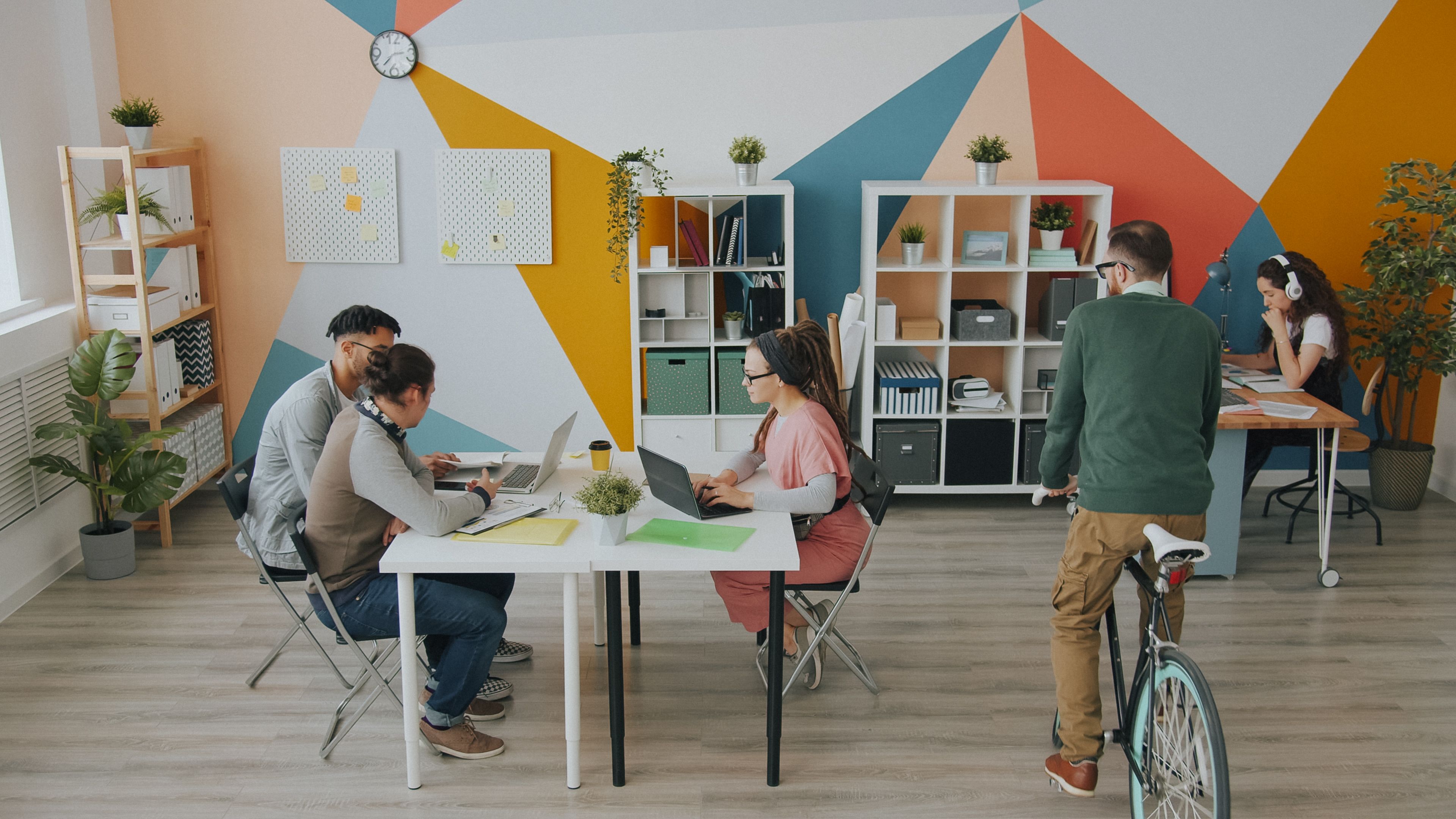 Three professionals discussing accounts together in a modern office