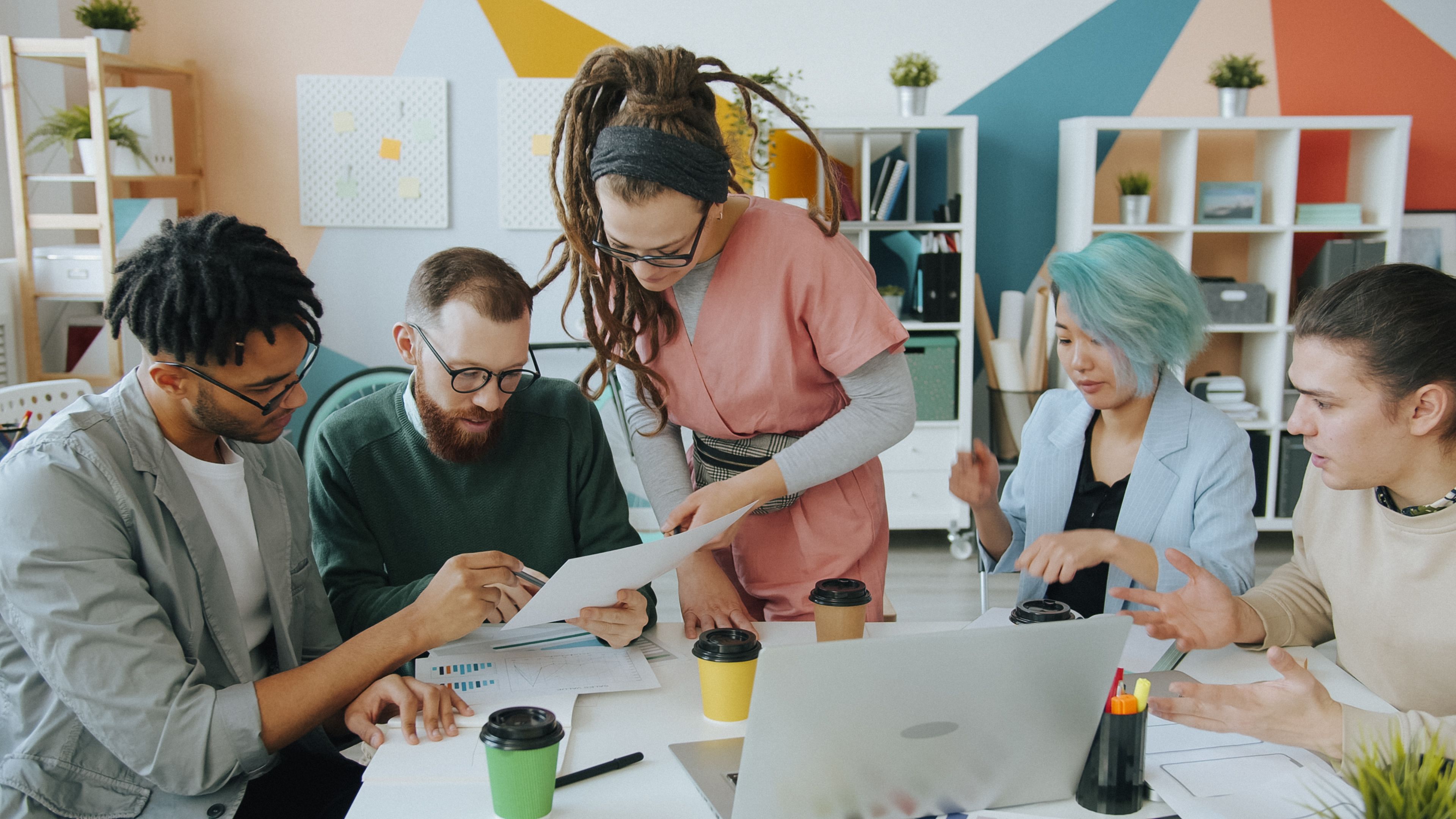 team reviewing content calendar laptop