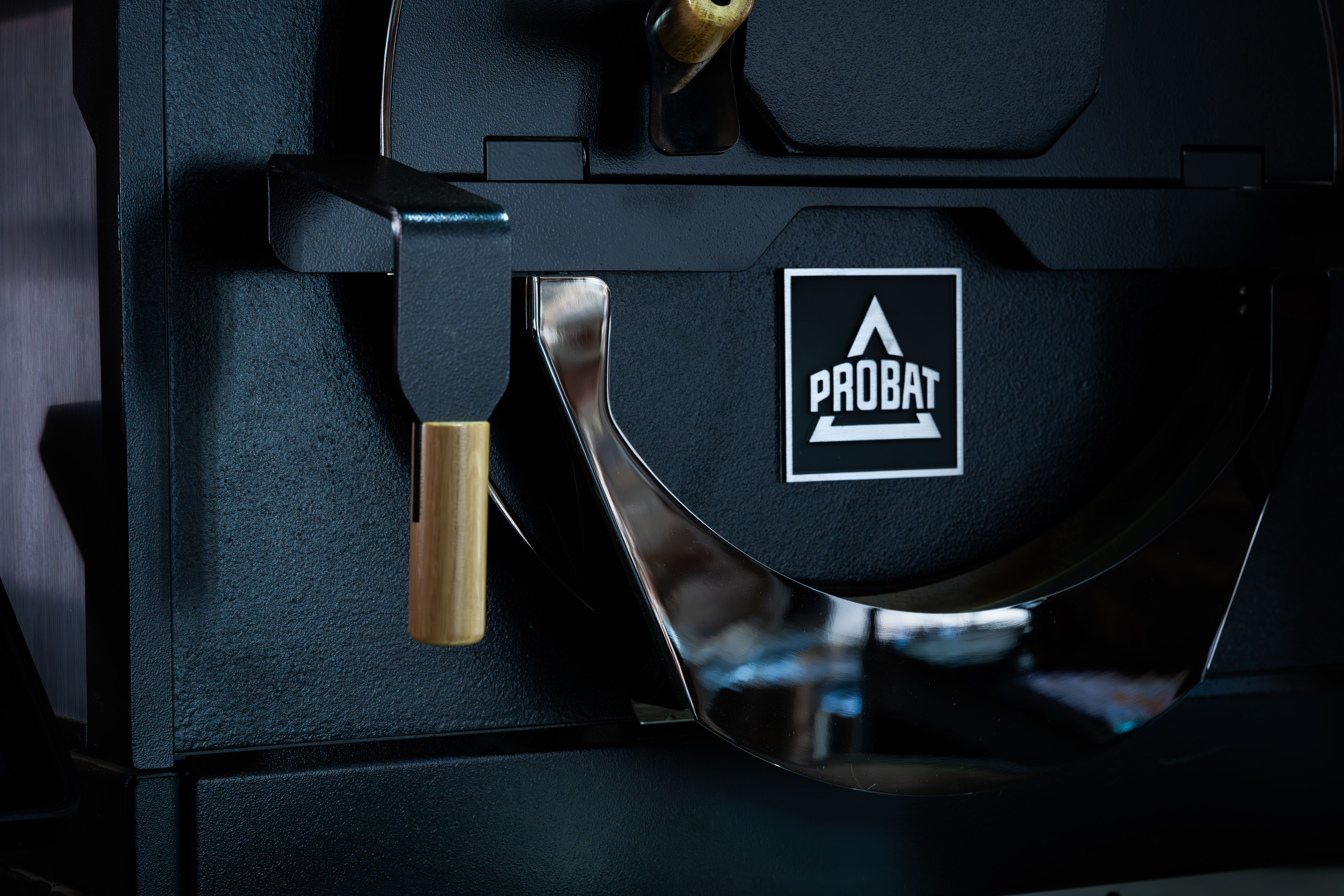 Detailed close-up of a Probat coffee roaster machine, showcasing industrial design and craftsmanship.