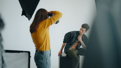Free Male model posing during a studio photo shoot with professional lighting. Stock Photo