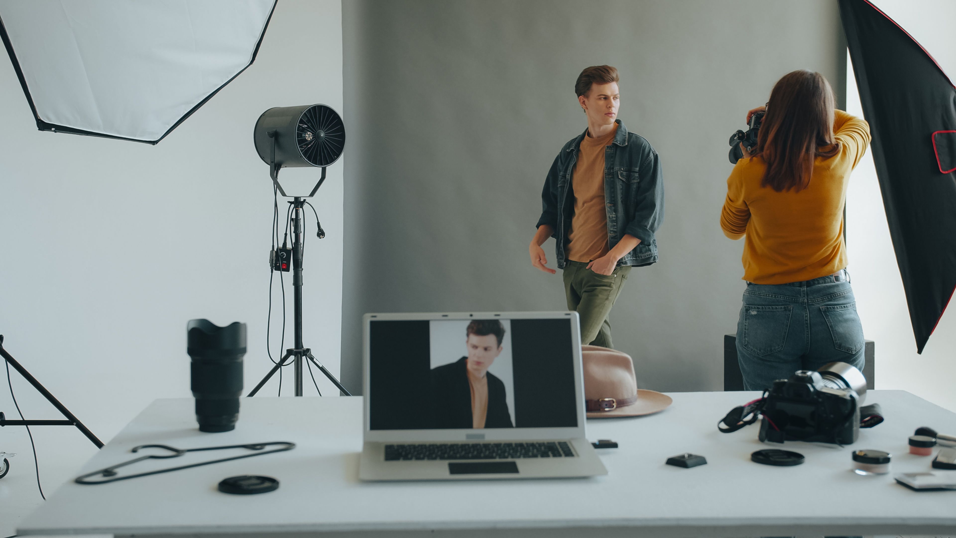 Model posing during a professional studio photoshoot with advanced photography equipment.