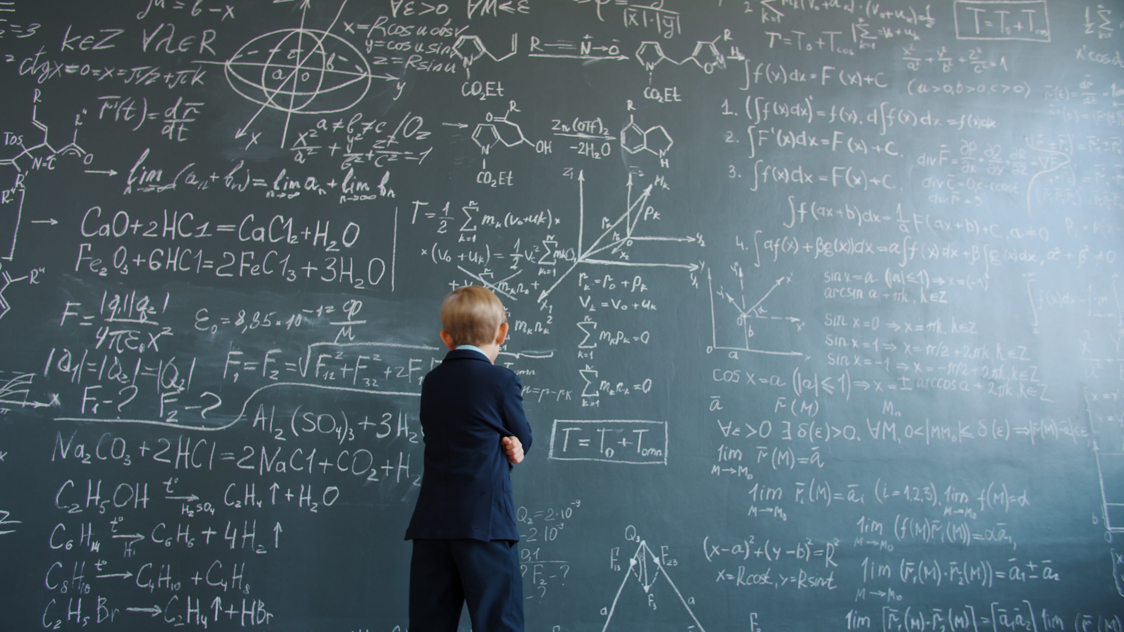 Chalkboard covered in handwritten formulas representing a scoring rubric
