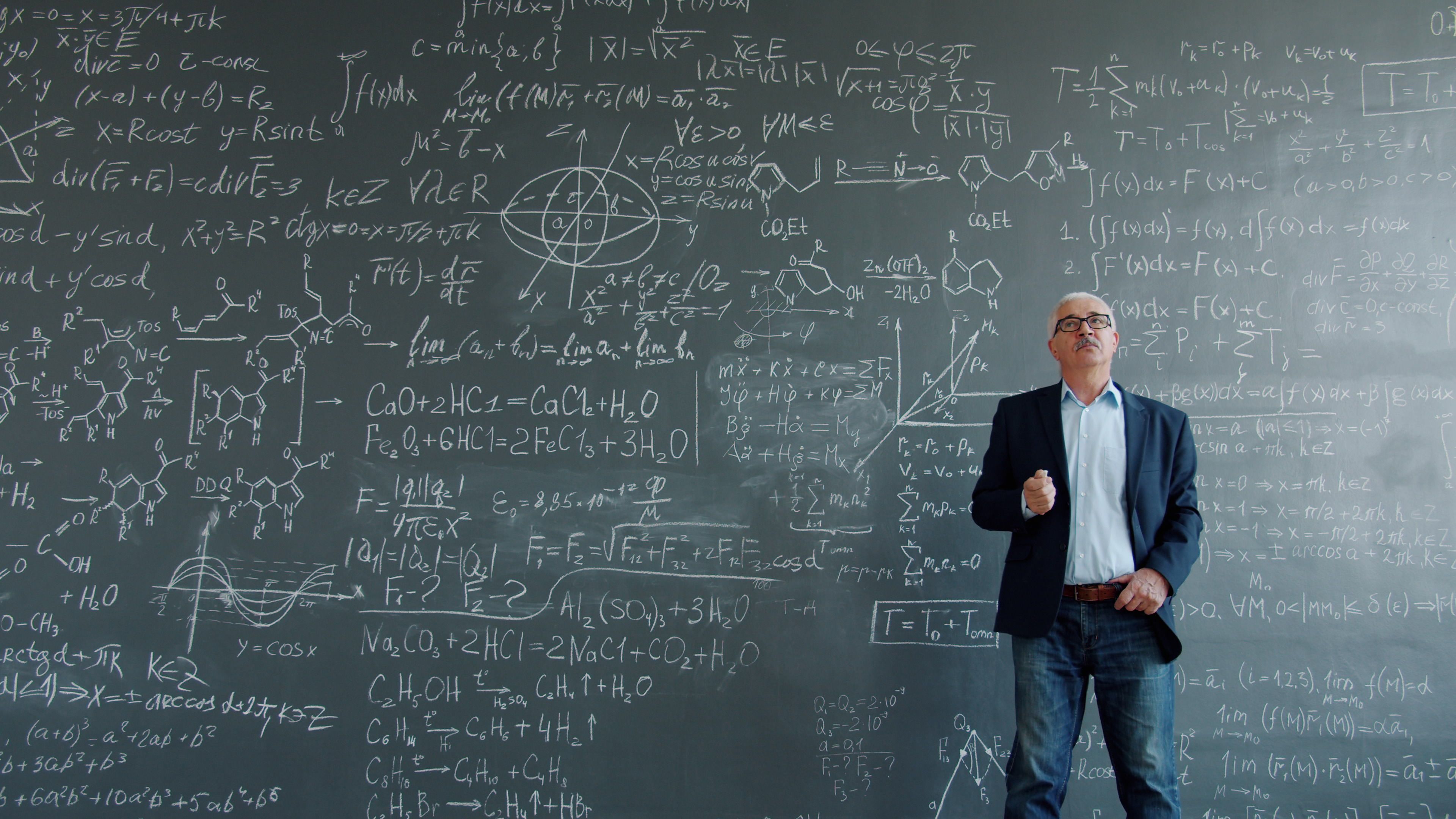 physicists debating research conference chalkboard equations