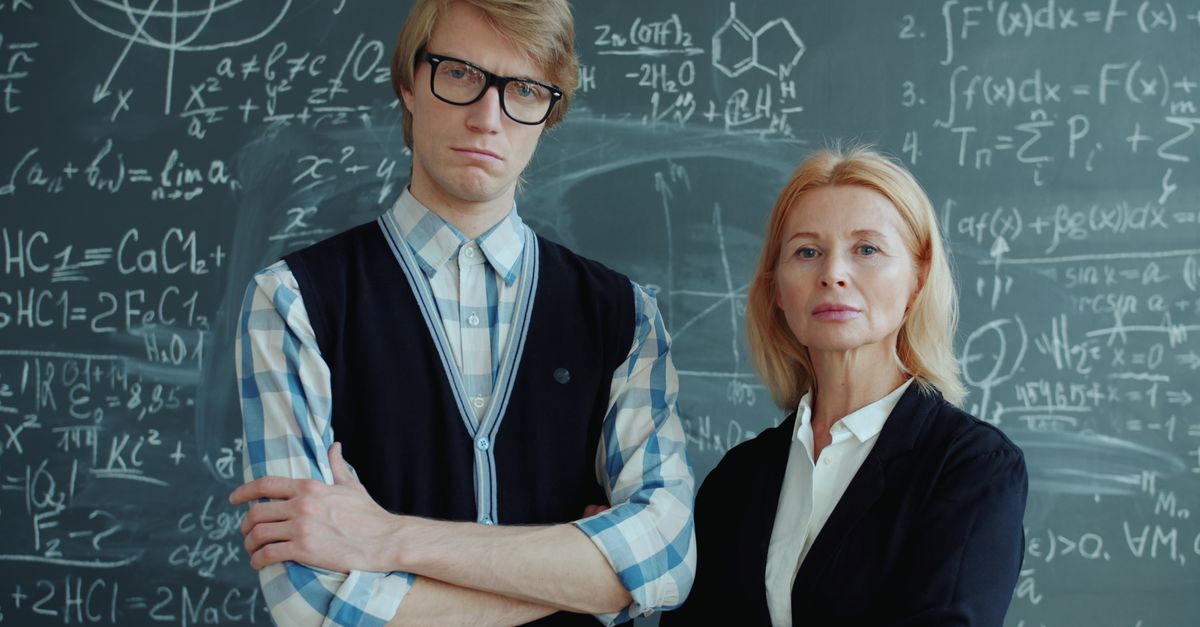 Teacher talking to student in classroom