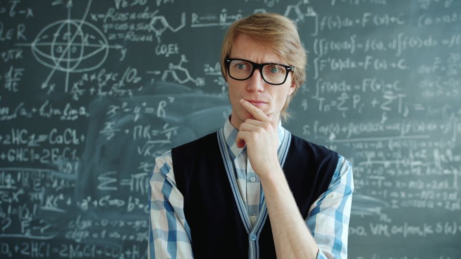 Thoughtful individual pondering mathematics on a chalkboard background.