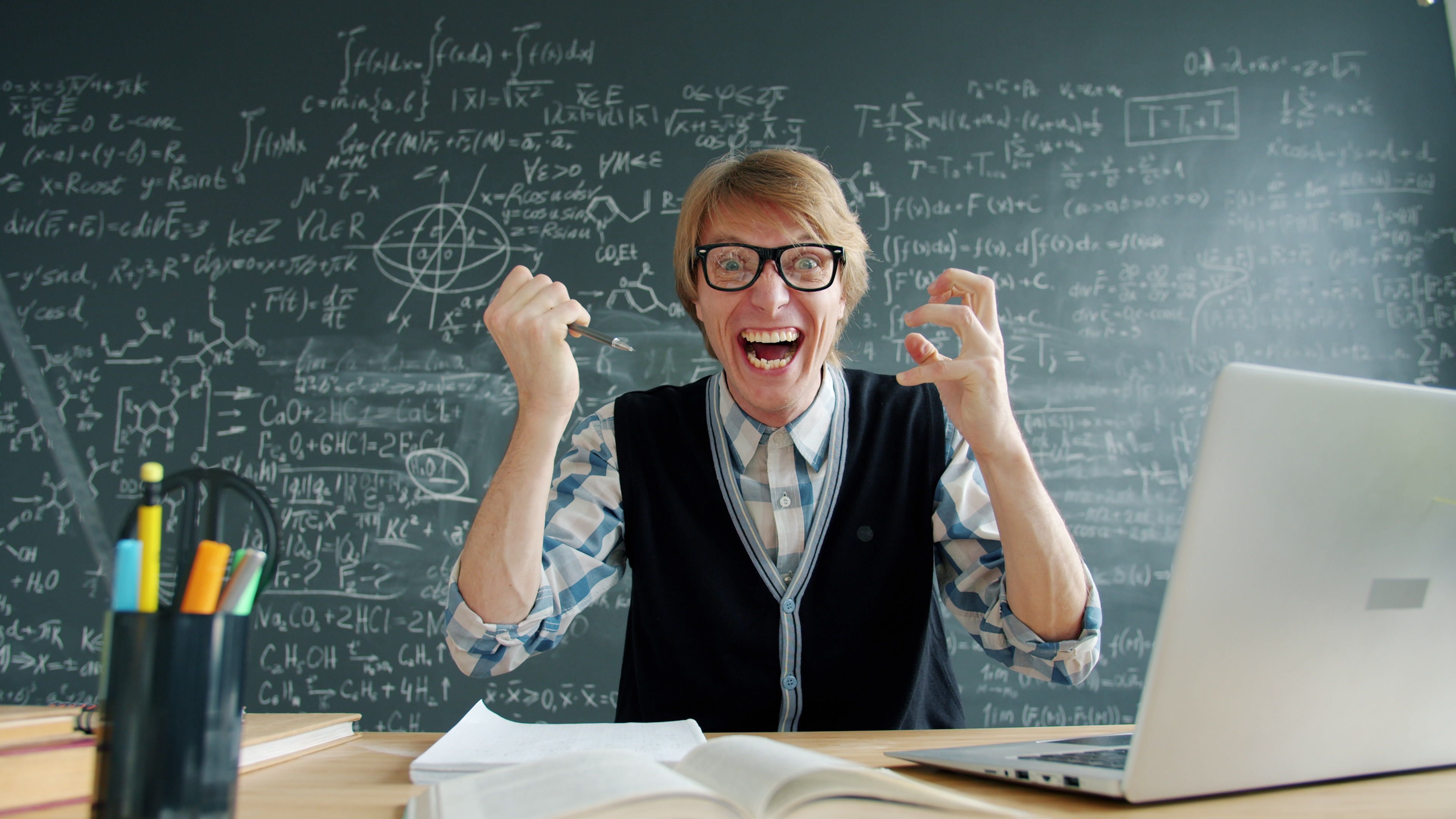 Excited Teacher in Classroom with Blackboard · Free Stock Photo
