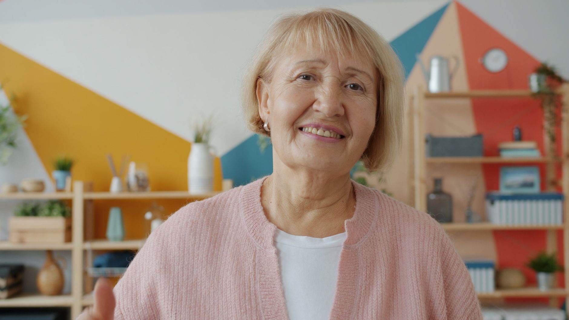 nmn for midlife energy crash women over 40 — Portrait of a senior woman smiling indoors with colorful background.