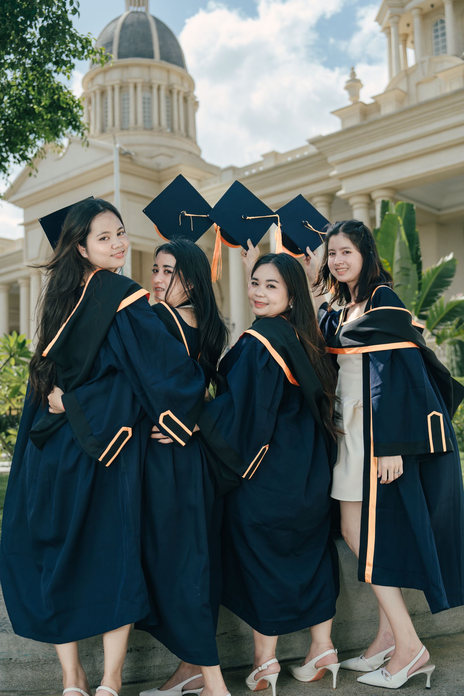 Graduates celebrating in caps and gowns
