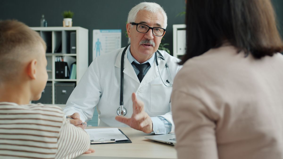Doctor discussing vaccine recommendations with a family during an office visit