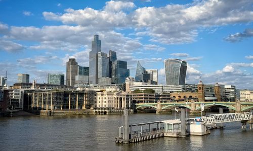 Free Stunning view of London's skyline featuring modern architecture and the Thames River under a bright blue sky. Stock Photo