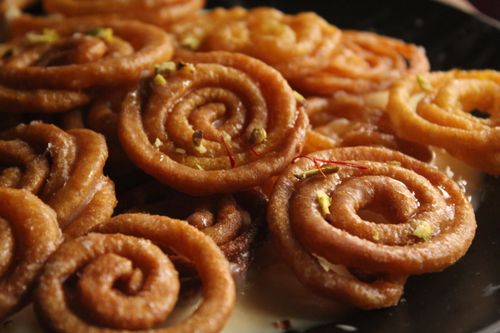 Free Close-up of traditional Indian jalebi dessert with syrup and pistachios. Stock Photo