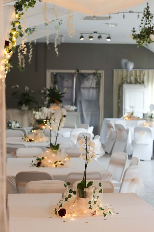 Free Charming indoor wedding setup with orchids and fairy lights. Stock Photo