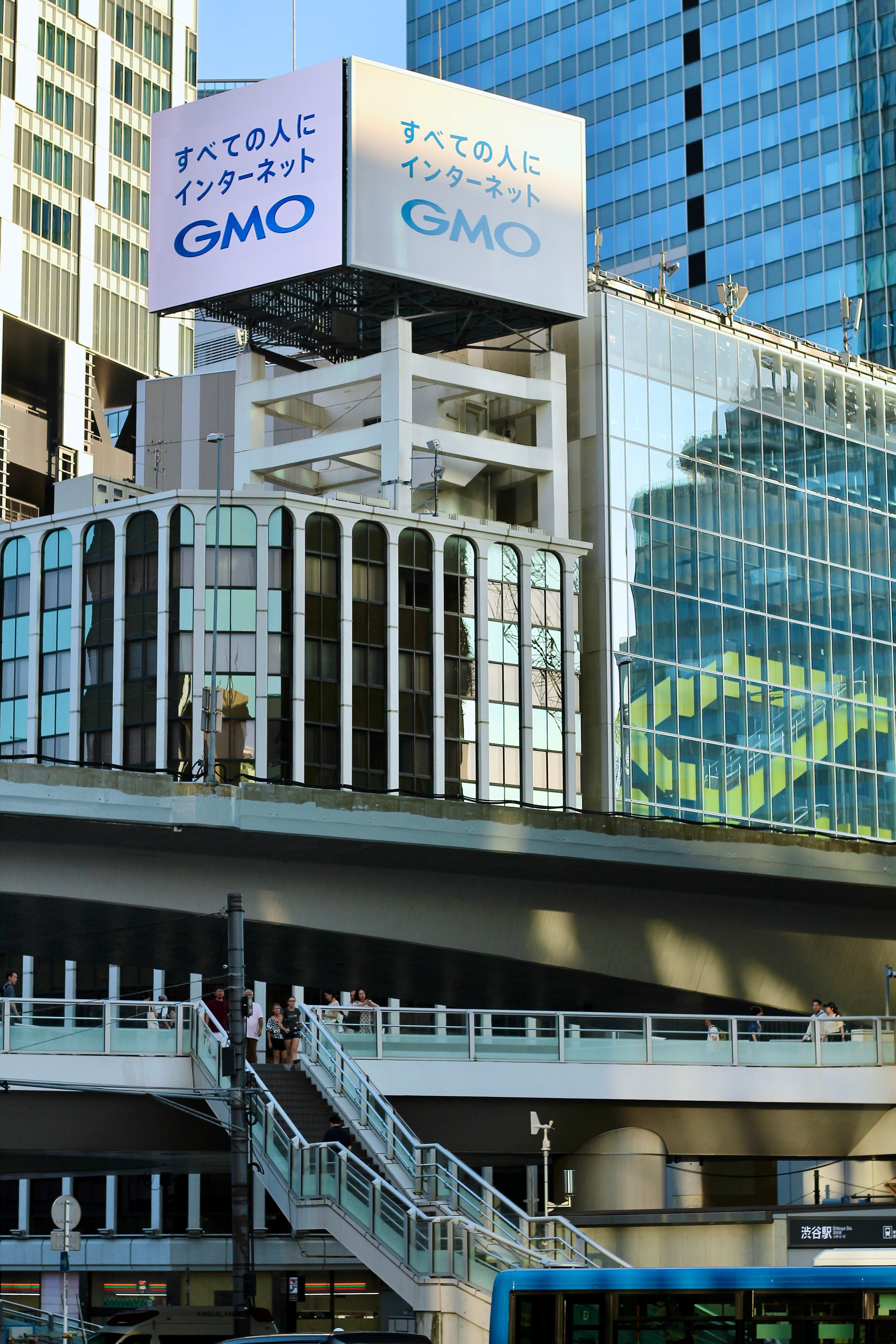 Reflective glass buildings in Tokyo's urban setting capture modern architecture and city life.