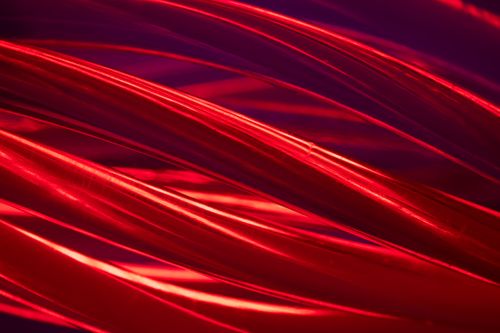 Free Vibrant abstract image featuring dynamic red curves and fluid lighting effects. Stock Photo