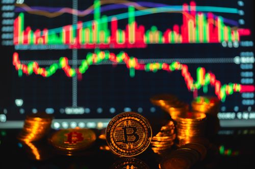 Free Golden Bitcoin coins in front of a financial graph, symbolizing cryptocurrency market trends. Stock Photo