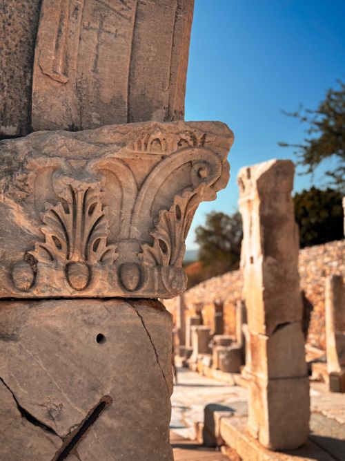 Free Close-up of a stone carving on ancient ruins under a clear blue sky during sunset, emphasizing historical architecture. Stock Photo
