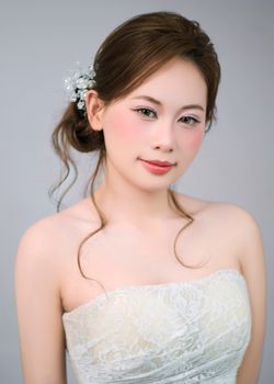 Beautiful portrait of a bride with floral hair accessory and lace gown.