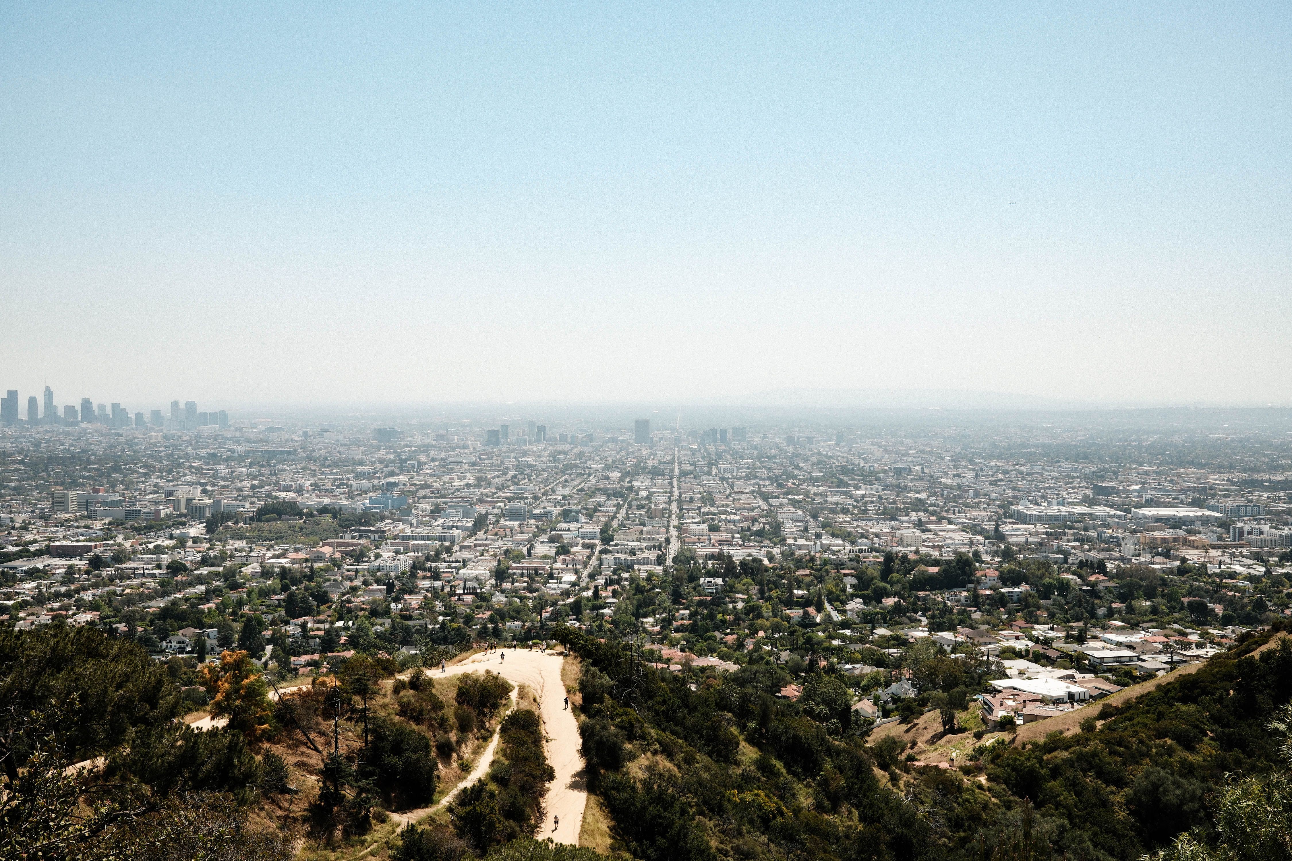 Aerial view of Los Angeles skyline featuring downtown and surrounding cityscape from Griffith Park.