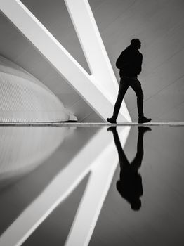 Silhouette reflection of a person in Valencia's modern architecture with sleek design