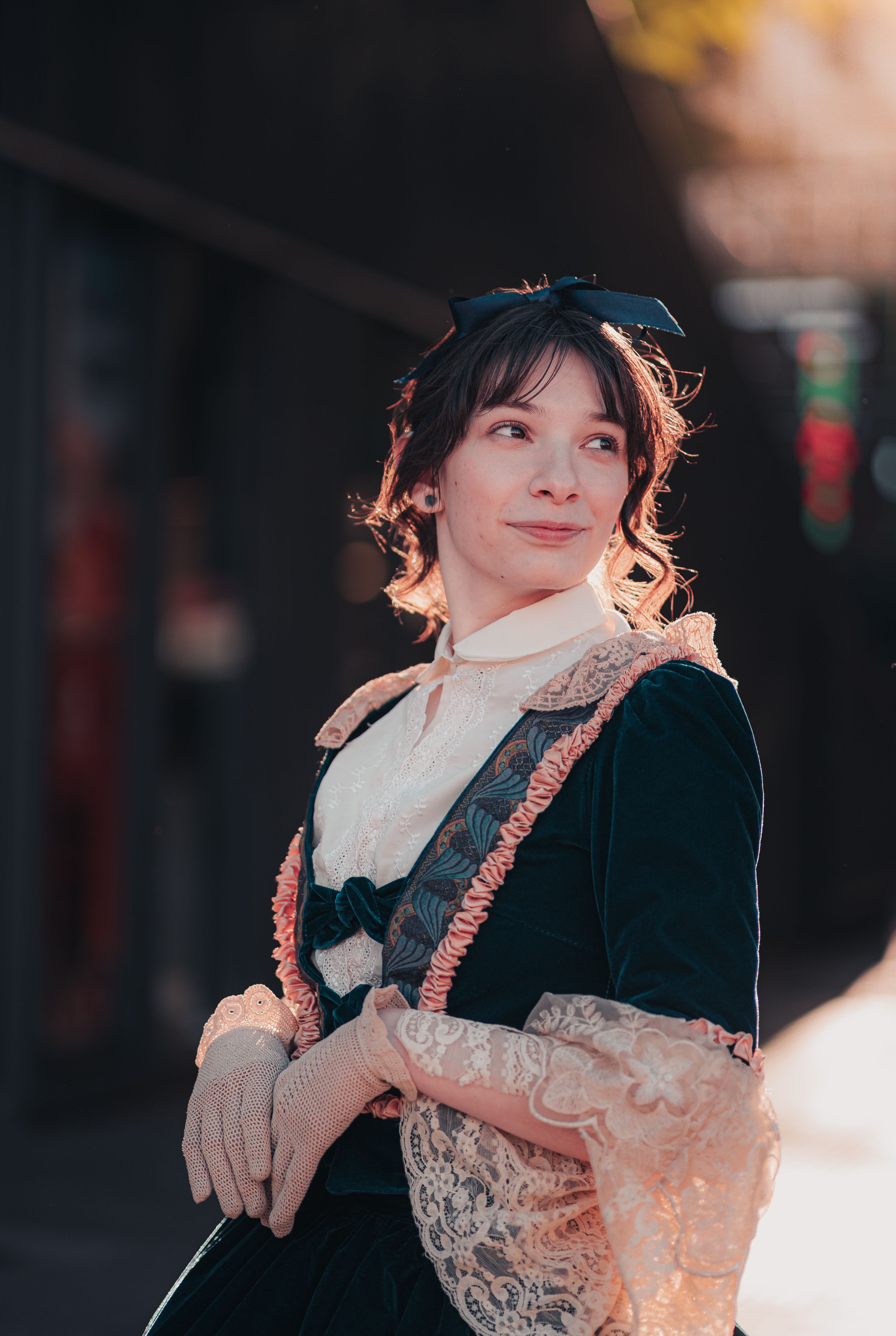 Woman in vintage attire poses elegantly outdoors in Buenos Aires, Argentina.