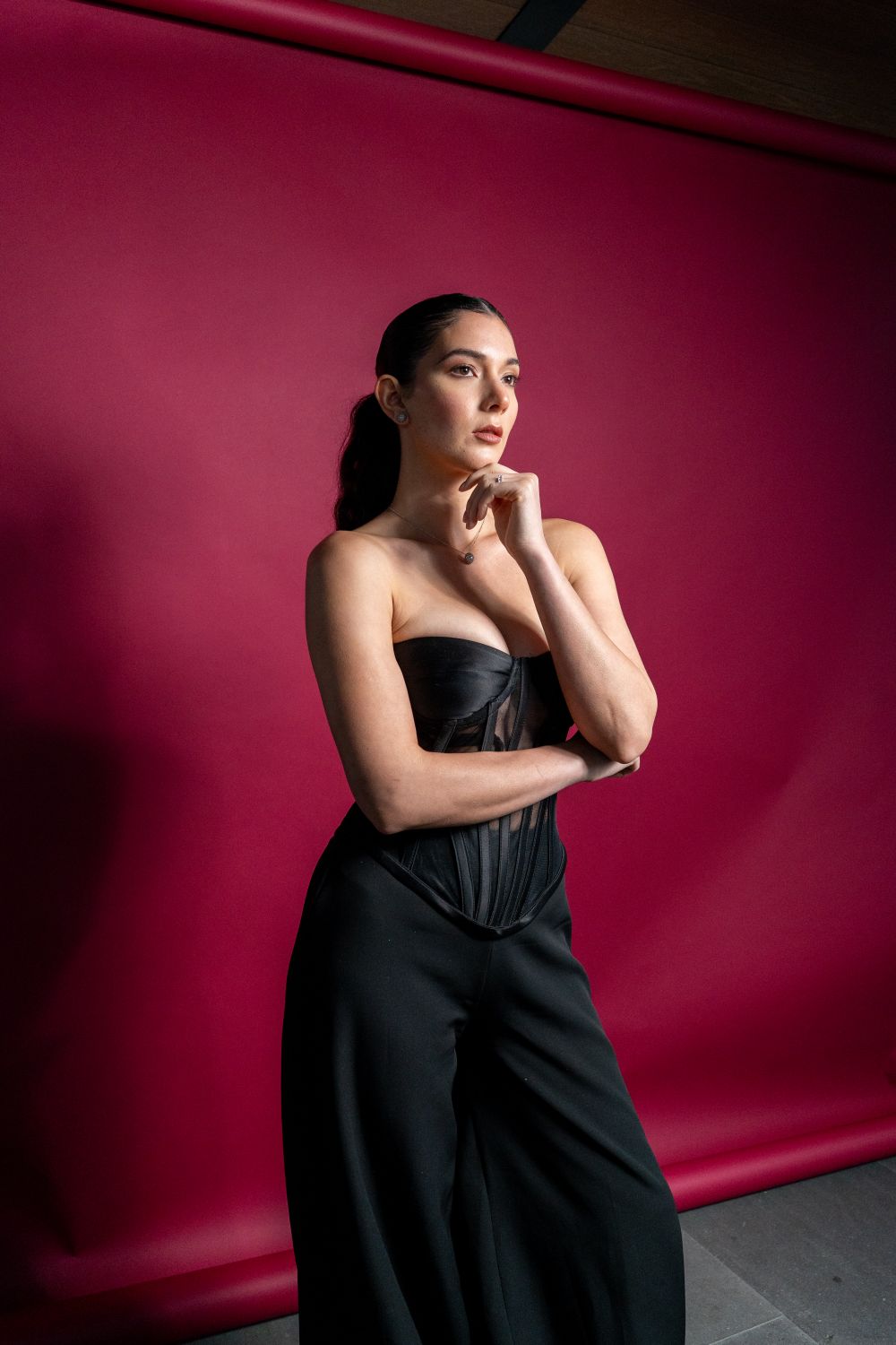 Fashion portrait against a red studio backdrop