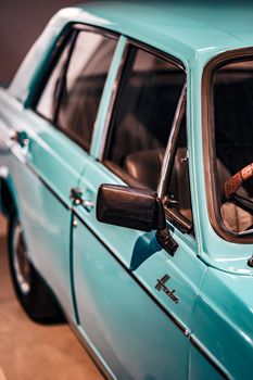 Close-up of a vintage blue car exhibiting classic design in Mysuru showroom.