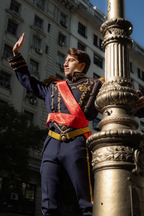 Free A man in historical military costume poses on a street in Buenos Aires, Argentina, capturing an elegant moment. Stock Photo
