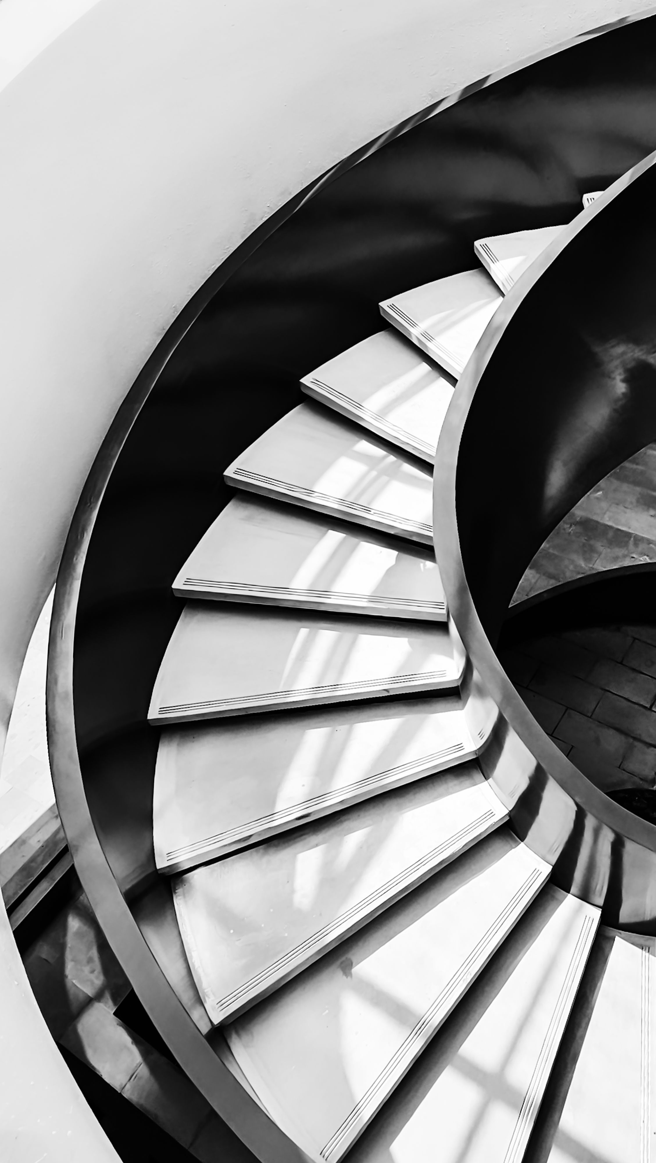 Artistic black and white photo of a spiral staircase showing modern architecture in Jakarta, Indonesia.