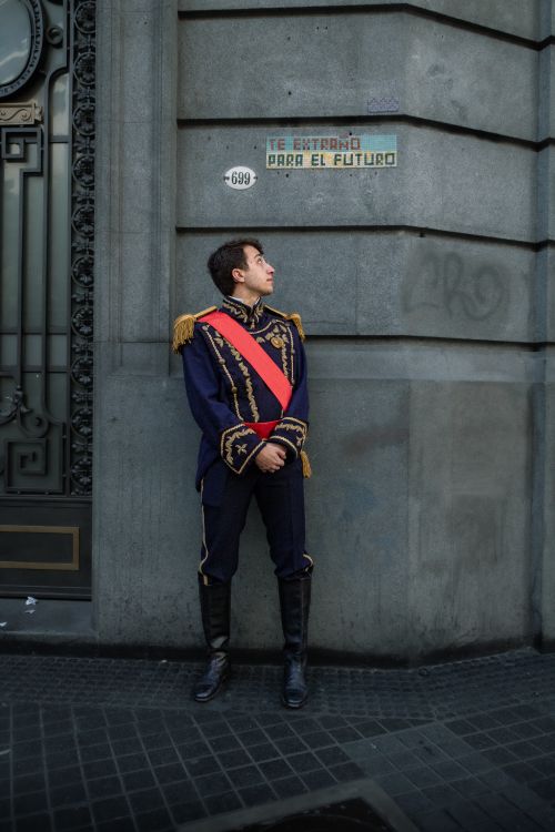 Free Man in traditional Argentine historical uniform standing by a wall in Buenos Aires. Stock Photo