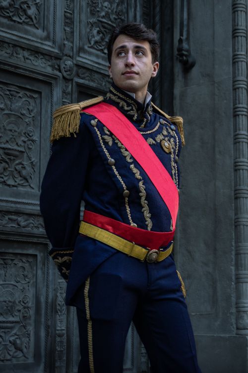 Free Portrait of a man in historical military attire by a detailed door in Buenos Aires, Argentina. Stock Photo
