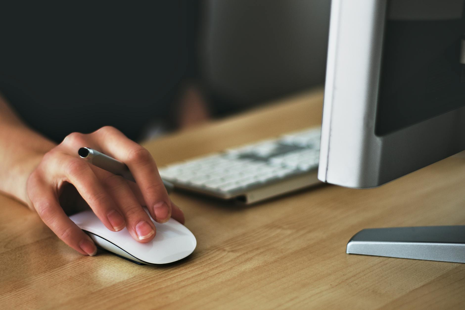 Person holding apple magic mouse