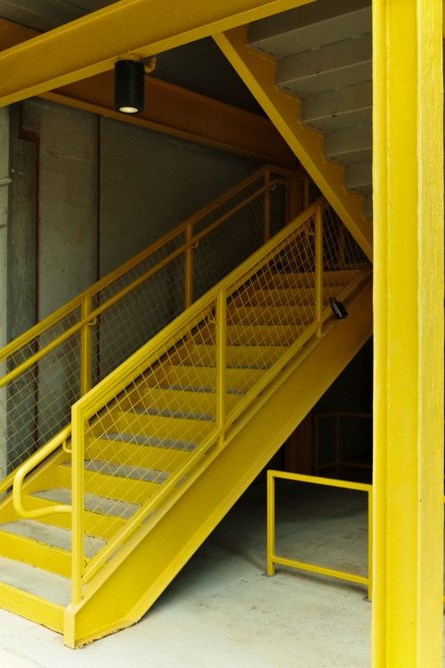 Free A striking yellow industrial staircase with geometric lines in Houston, Texas. Stock Photo